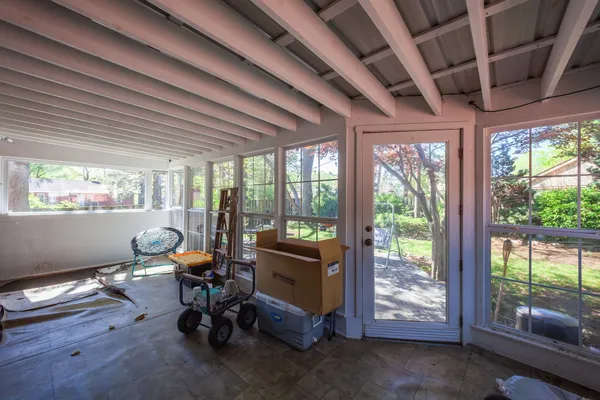 a view of a room with gym equipment and large windows