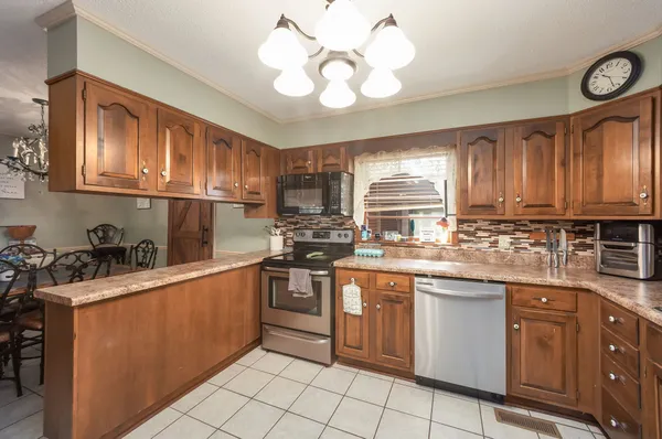 a kitchen with stainless steel appliances granite countertop a sink and cabinets