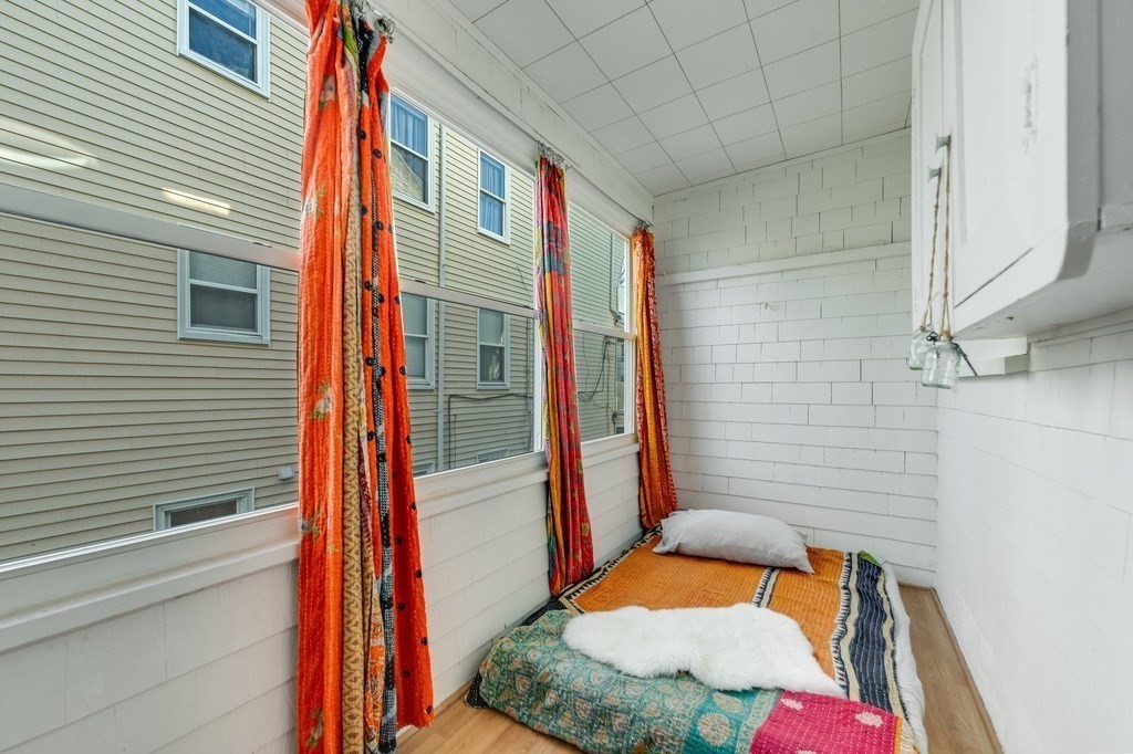 21 Ericsson Street, Unit 2 Cambridge, MA 02138 - Photo 19 of 22 a bedroom with a bed and chair