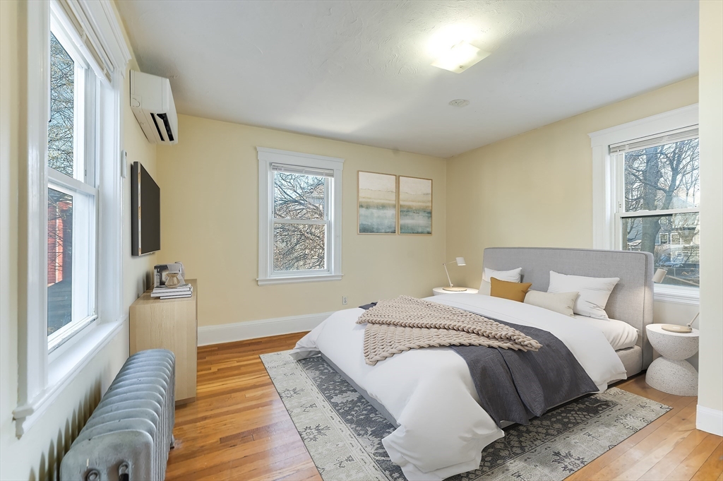 21 Ericsson Street, Unit 2 Cambridge, MA 02138 - Photo 8 of 22 a spacious bedroom with a bed and wooden floor