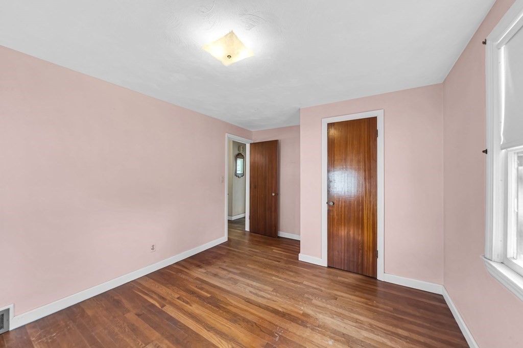 14 Franconia Street Springfield, MA 01108 - Photo 14 of 27 a view of an empty room with wooden floor and a window