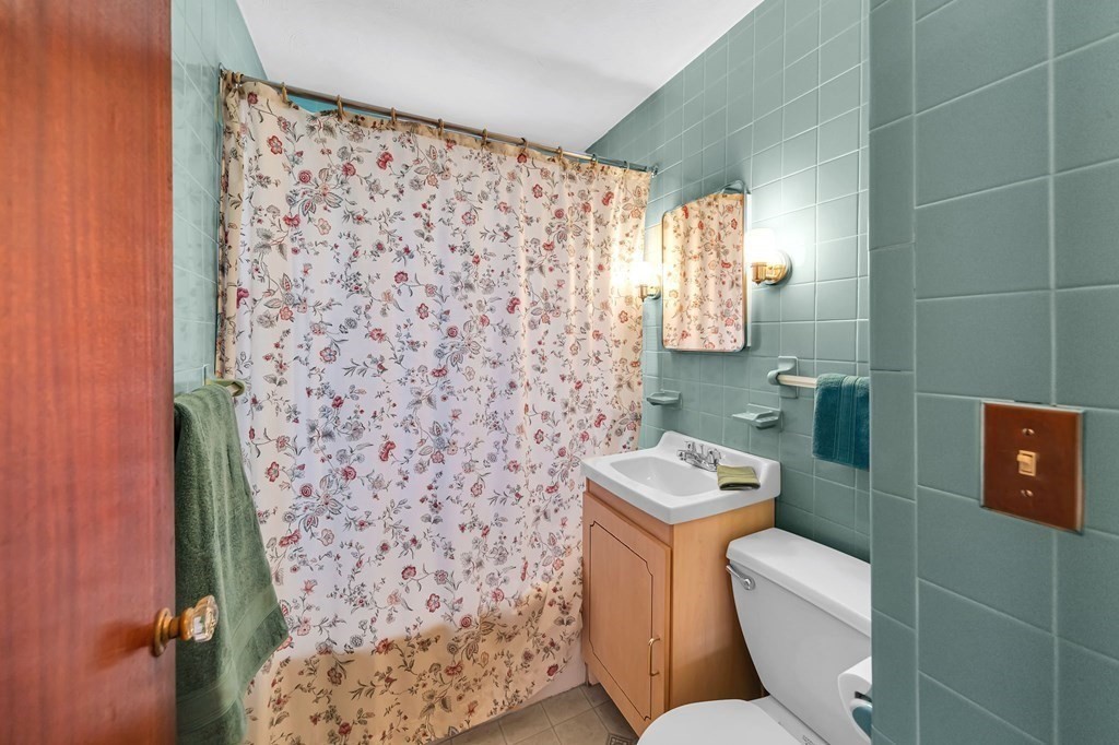14 Franconia Street Springfield, MA 01108 - Photo 16 of 27 a bathroom with a toilet and a shower curtain