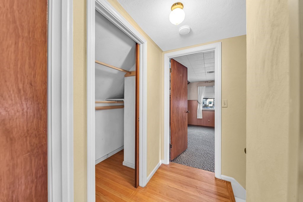 14 Franconia Street Springfield, MA 01108 - Photo 21 of 27 a view of a hallway with wooden floor and a bathroom