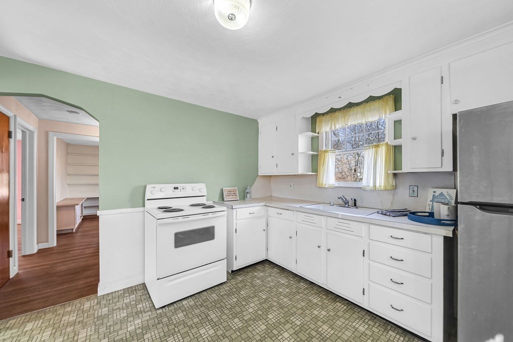 14 Franconia Street Springfield, MA 01108 - Photo 6 of 27 a kitchen with white cabinets and white appliances