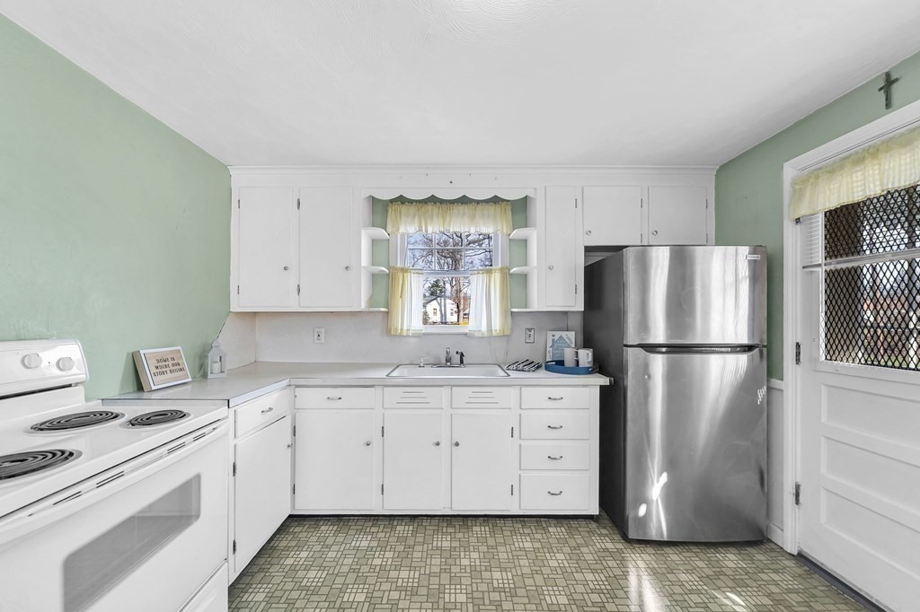 14 Franconia Street Springfield, MA 01108 - Photo 8 of 27 a kitchen with a sink a refrigerator and a stove