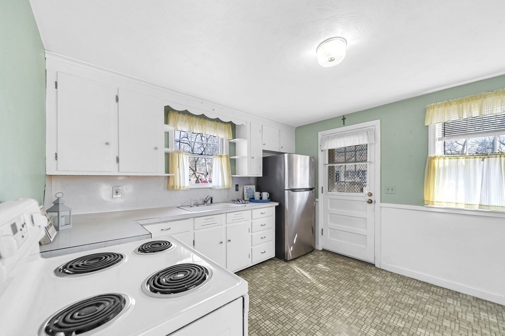 14 Franconia Street Springfield, MA 01108 - Photo 9 of 27 a kitchen with a stove a sink and a refrigerator