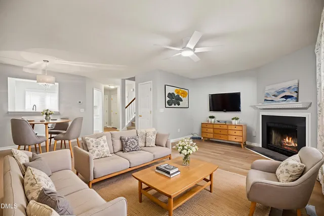 a living room with furniture a fireplace and a flat screen tv