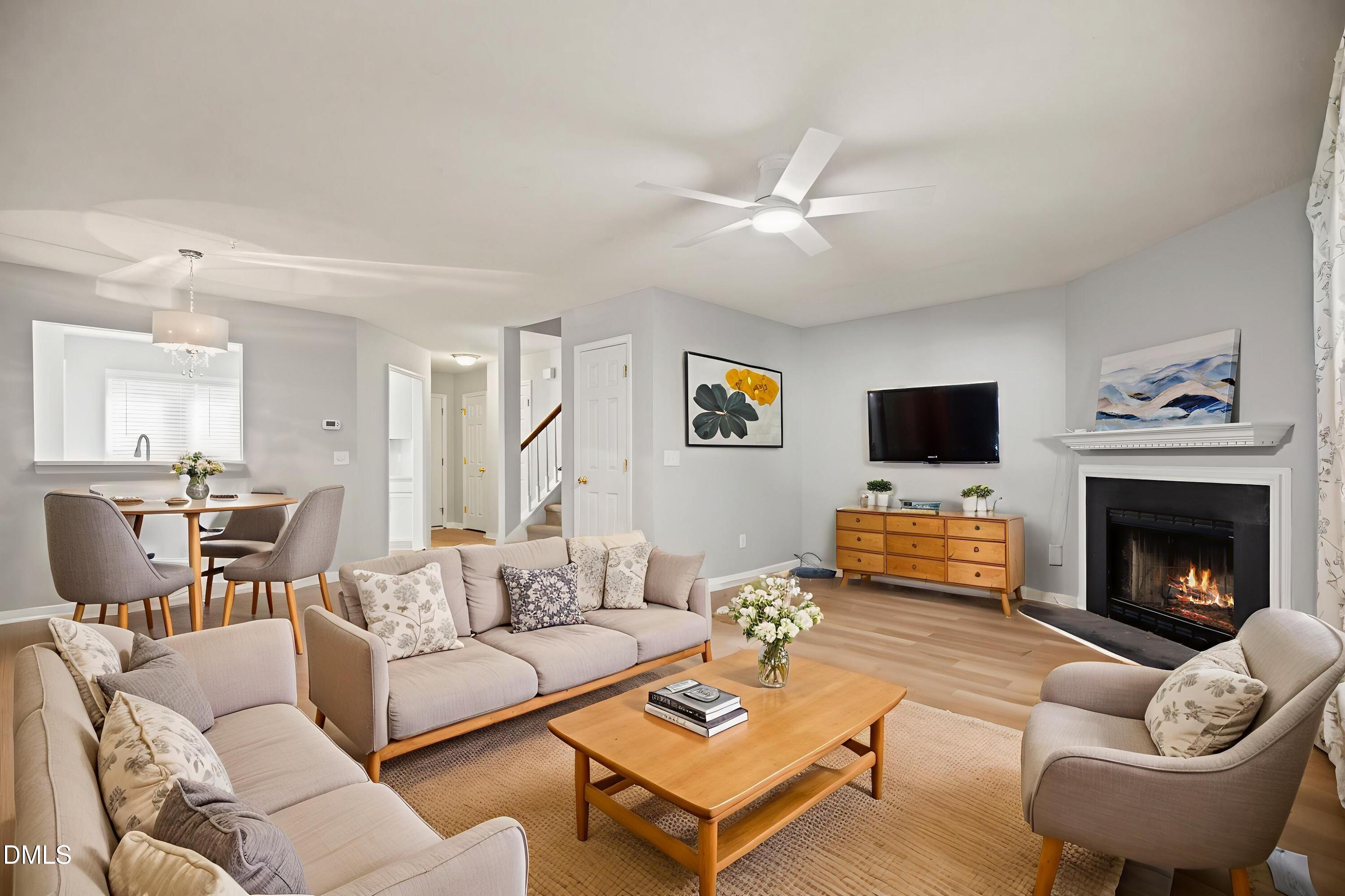 6063 Epping Forest Drive Raleigh, NC 27613 - Photo 11 of 34 a living room with furniture a fireplace and a flat screen tv