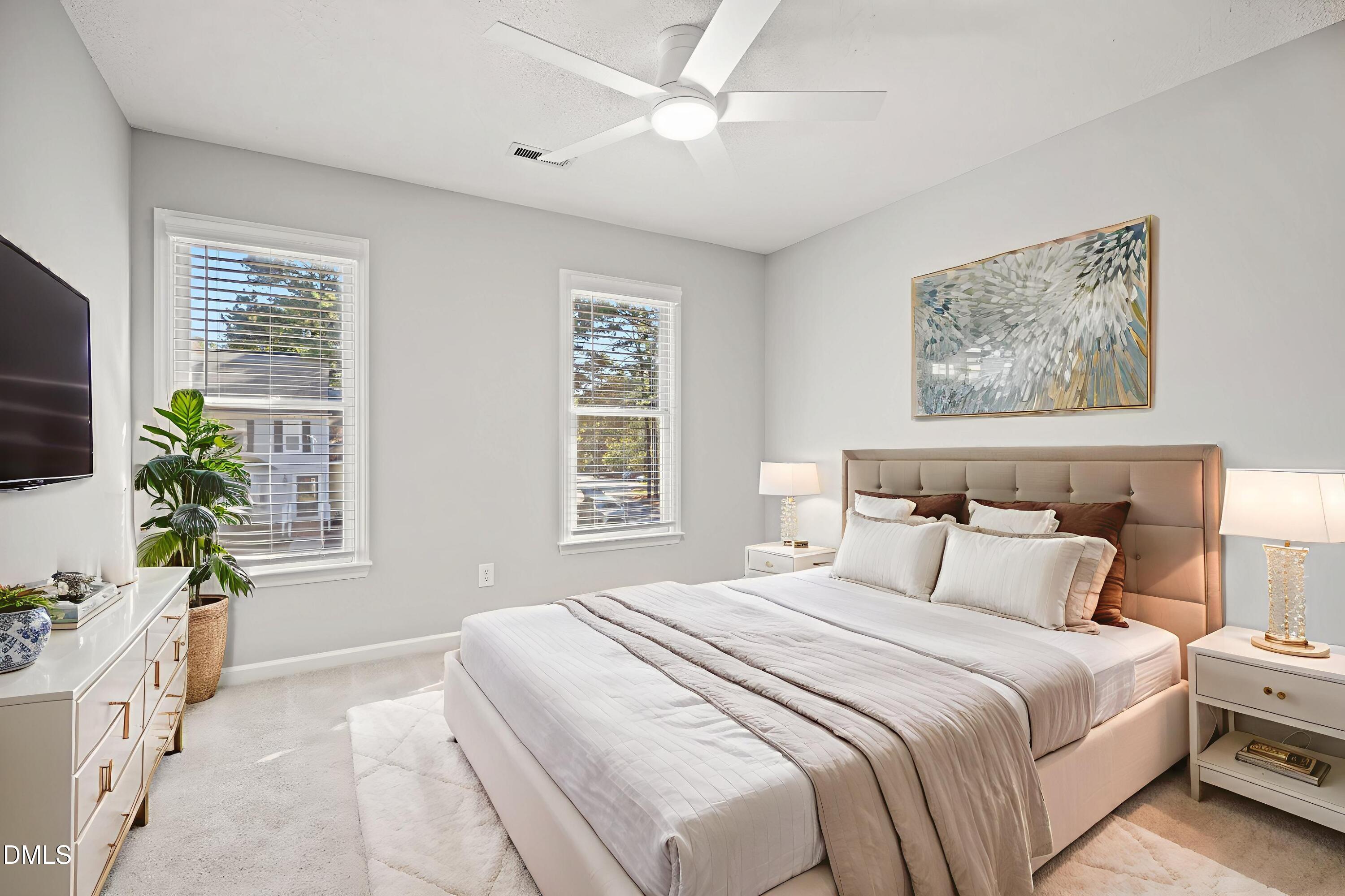 6063 Epping Forest Drive Raleigh, NC 27613 - Photo 14 of 34 a bedroom with a large bed a chandelier and a window