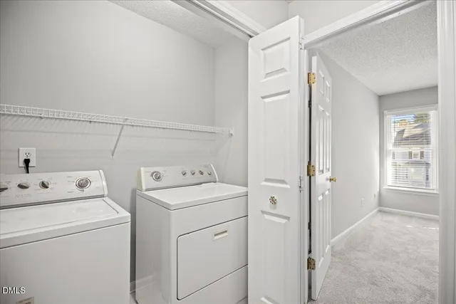 a view of storage and utility room with washer and dryer
