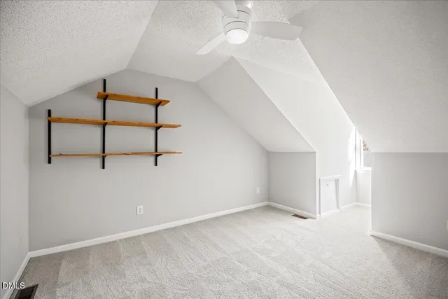 a view of staircase with white walls and a window