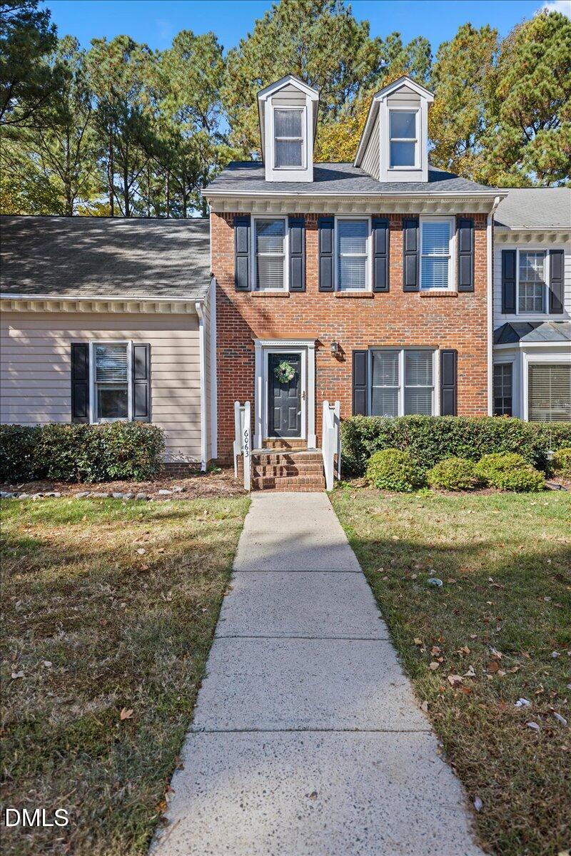6063 Epping Forest Drive Raleigh, NC 27613 - Photo 3 of 34 a front view of a house with garden