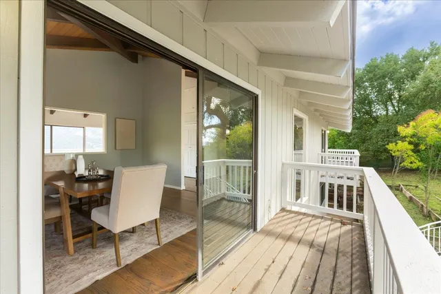 a dining room with furniture a chandelier and wooden floor