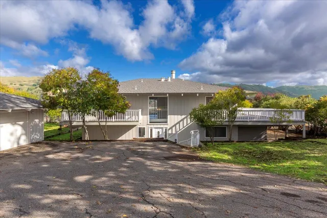 a view of a house with a fountain and a yard