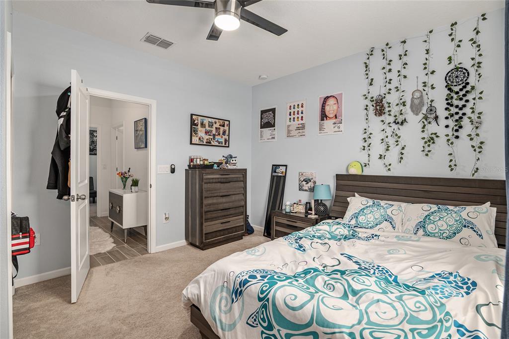 5688 Southwest 92nd Place Ocala, FL 34476 - Photo 35 of 54 a bedroom with a bed and a view of bathroom