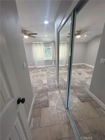 a spacious bathroom with a granite countertop sink toilet and a mirror