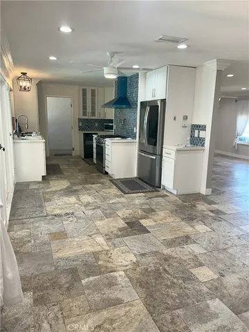 a kitchen with stainless steel appliances granite countertop cabinets and window