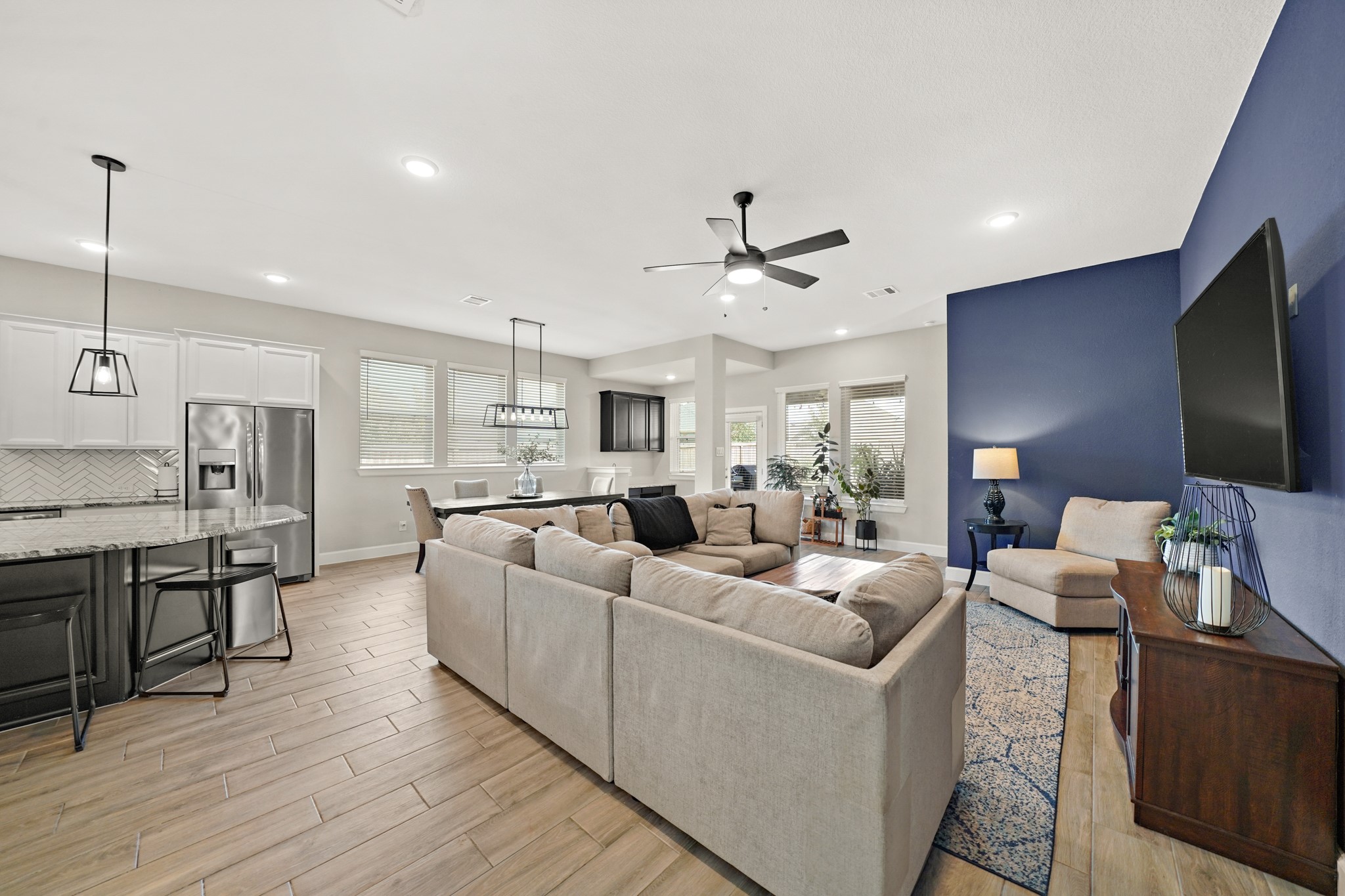 6635 Waxbill Road Katy, TX 77493 - Photo 11 of 33 a living room with furniture kitchen view and a flat screen tv