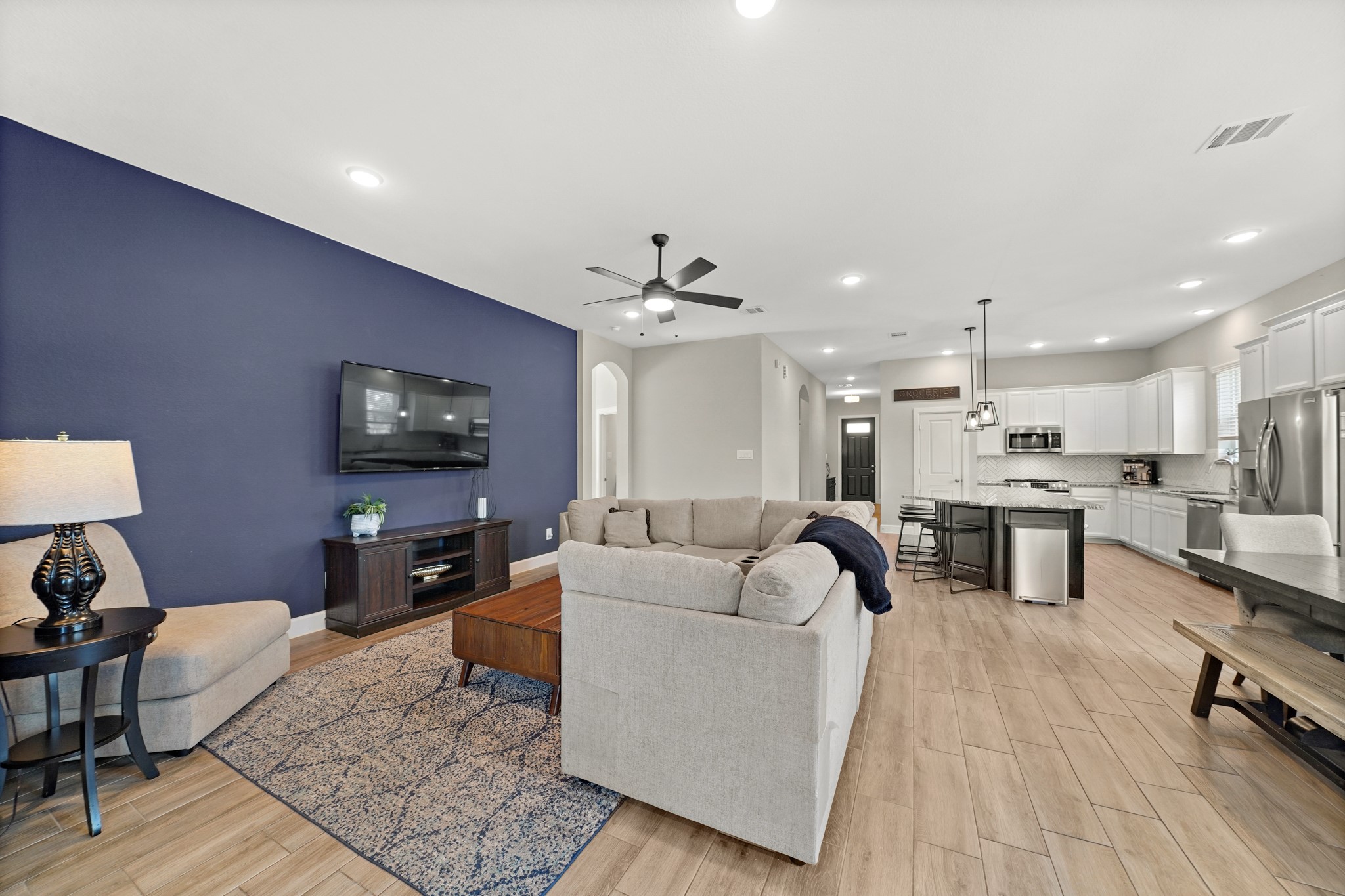 6635 Waxbill Road Katy, TX 77493 - Photo 12 of 33 a living room with furniture and a flat screen tv