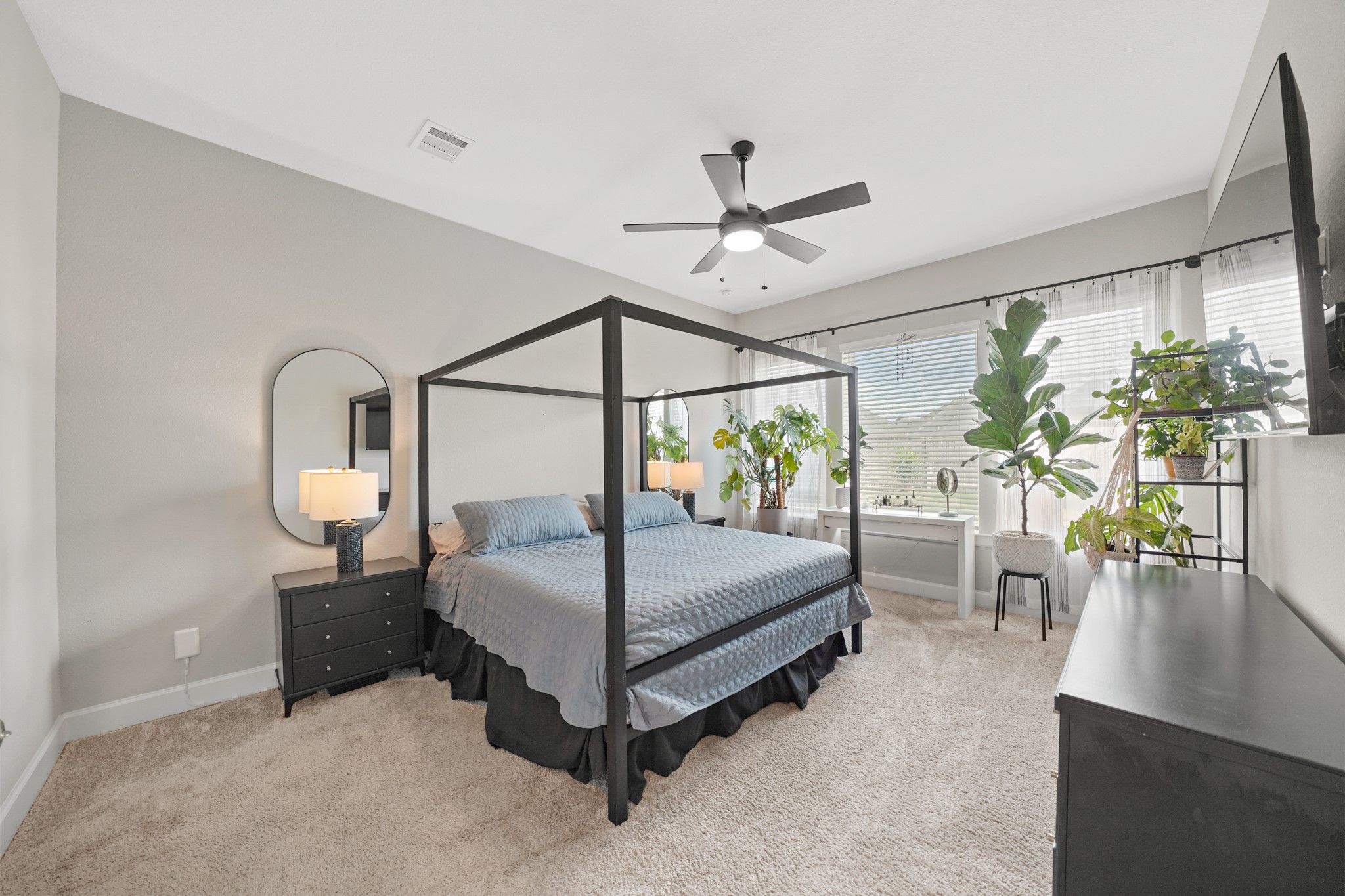 6635 Waxbill Road Katy, TX 77493 - Photo 16 of 33 a bedroom with a bed a chandelier and a window