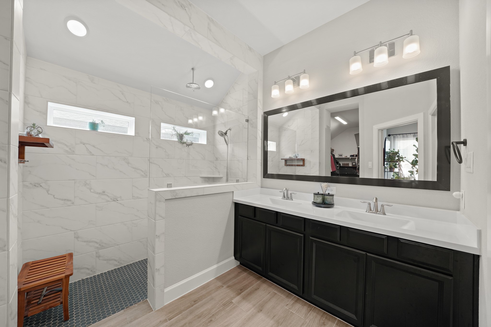 6635 Waxbill Road Katy, TX 77493 - Photo 17 of 33 a bathroom with a double vanity sink a mirror and a shower