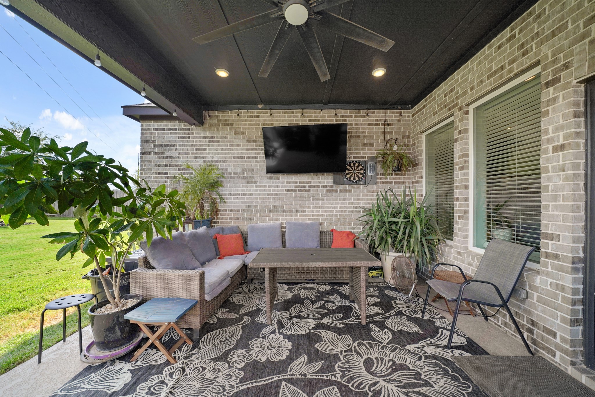6635 Waxbill Road Katy, TX 77493 - Photo 23 of 33 a outdoor living space with furniture and a flat screen tv