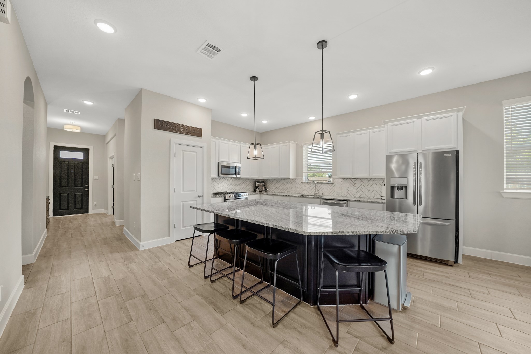 6635 Waxbill Road Katy, TX 77493 - Photo 7 of 33 a large kitchen with a table and chairs