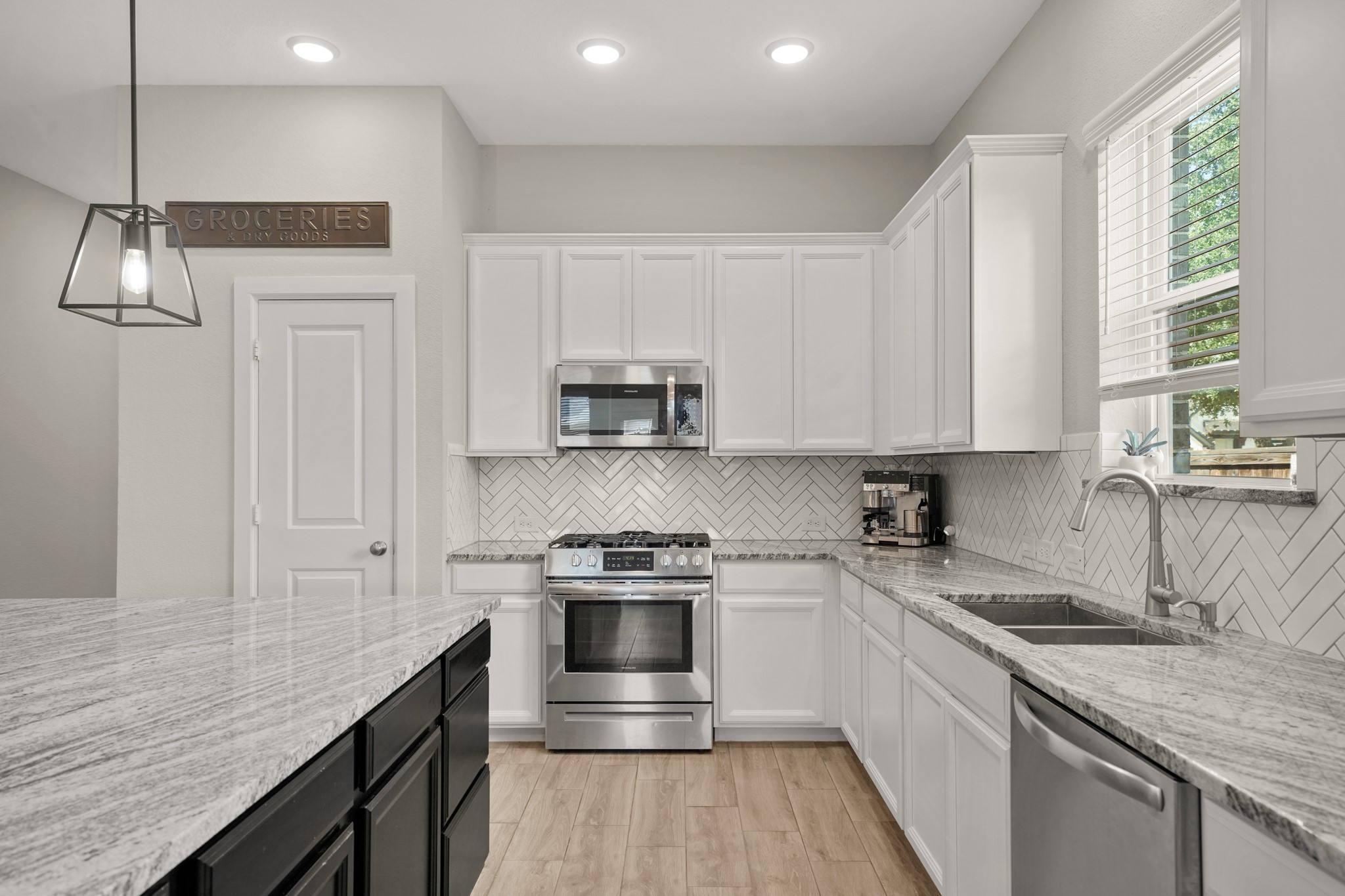 6635 Waxbill Road Katy, TX 77493 - Photo 8 of 33 a kitchen with stainless steel appliances granite countertop a sink stove and refrigerator