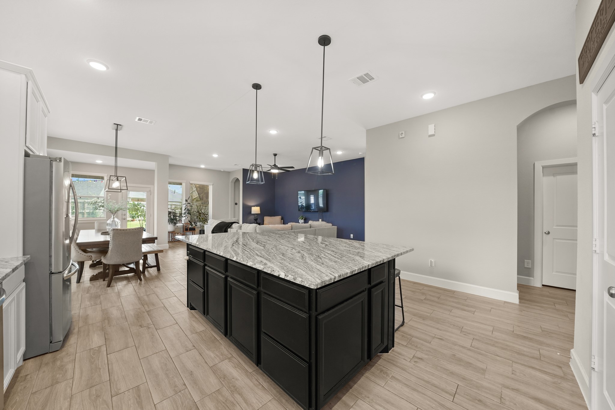 6635 Waxbill Road Katy, TX 77493 - Photo 10 of 33 a kitchen with a stove and wooden floor