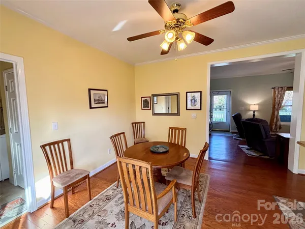 a view of a dining room with furniture wooden floor and a chandelier