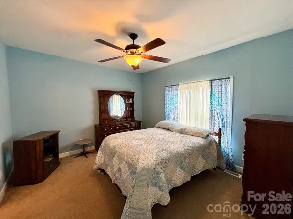 a bed sitting in a bedroom next to a window