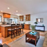 a living room with furniture a dining table and kitchen view