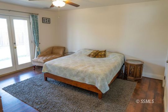 644 Beth Lane Ridgecrest, CA 93555 - Photo 21 of 31 a bedroom with a bed and wooden floor