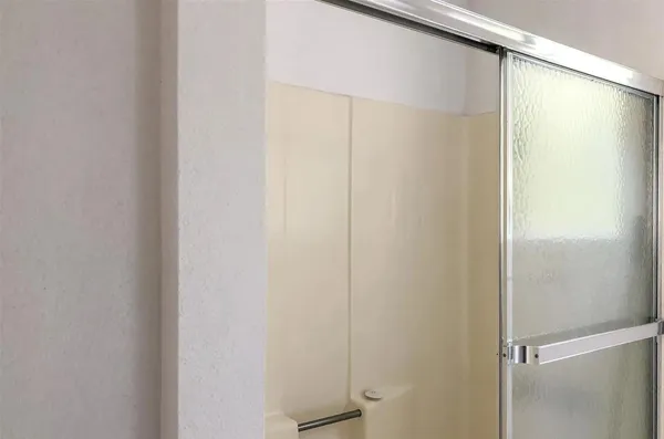 a bathroom with a glass shower door