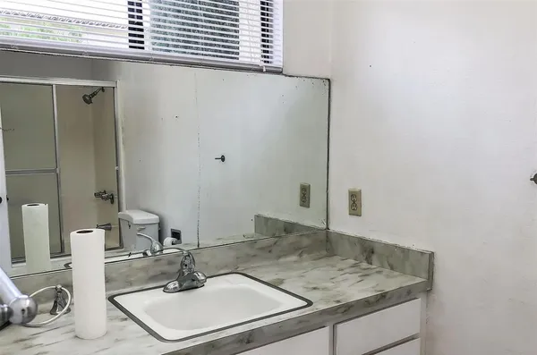 a bathroom with a sink and a mirror