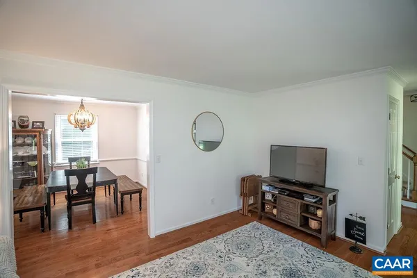 a view of entryway and hall with wooden floor