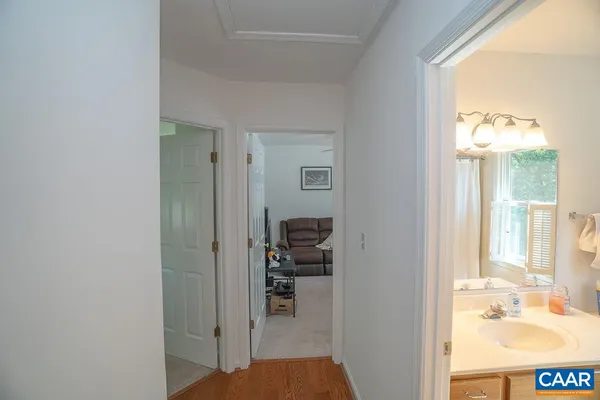 a view of a hallway with wooden floor and stairs
