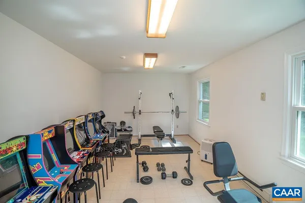an aerial view of residential house with outdoor space and trees all around