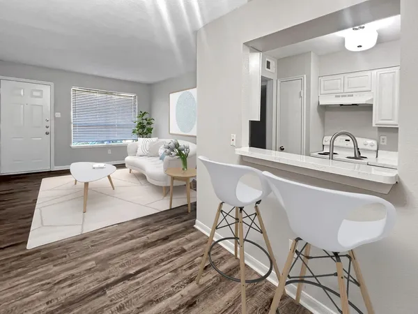 a living room with furniture and wooden floor
