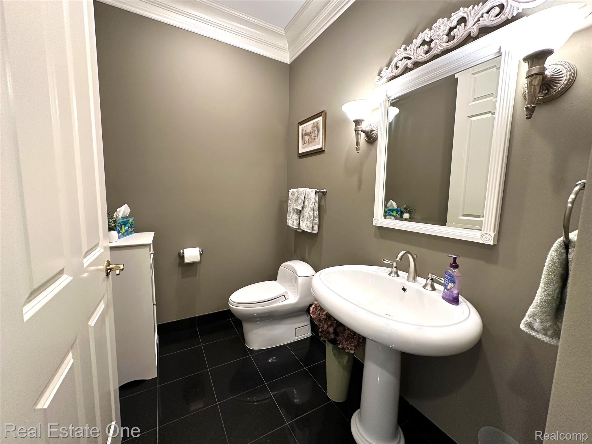 3648 West Tienken Road Rochester, MI 48306 - Photo 25 of 61 Half Bath with Pedestal Sink, Granite Flooring and Extensive Crown Molding.