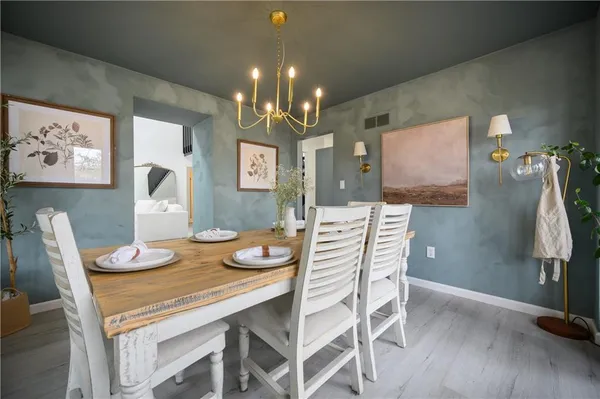 a dining room with furniture and wooden floor