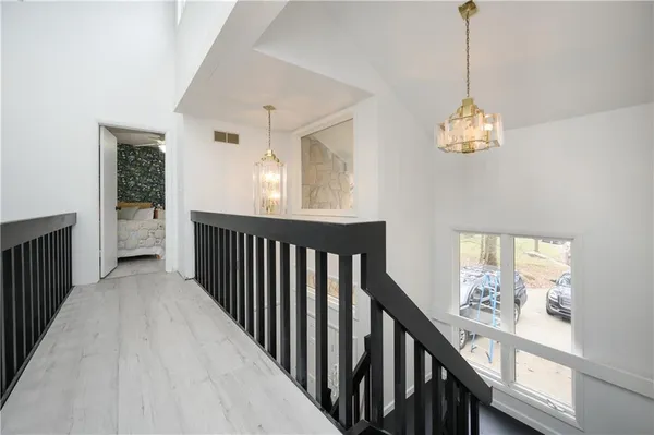 a view of a hallway to bedroom with wooden floor