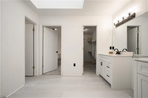 a bathroom with a double vanity sink and mirror