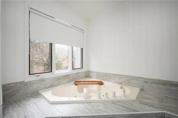 a bathroom with a bathtub and window