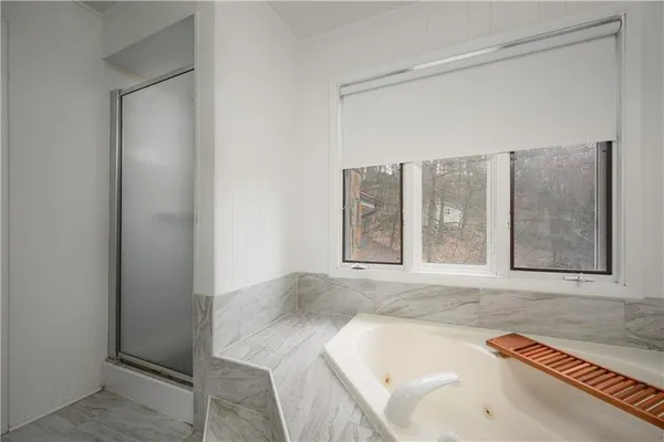 a bathroom with a tub and a sink