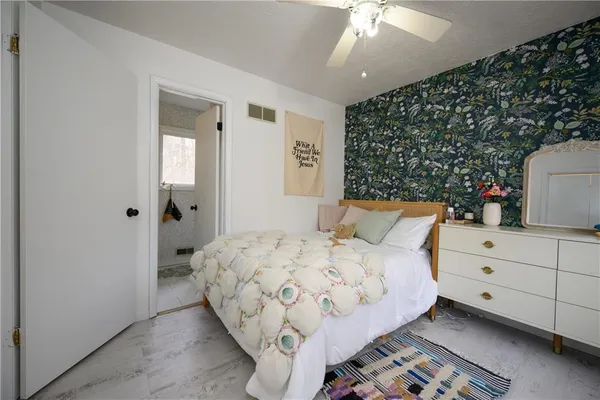 a bedroom with a bed and a dresser