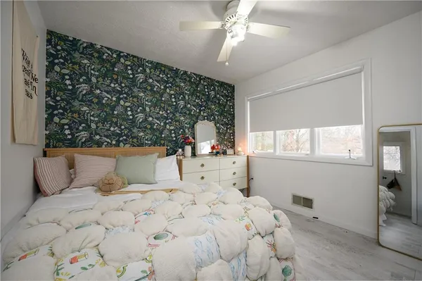 a bedroom with a large bed and a window