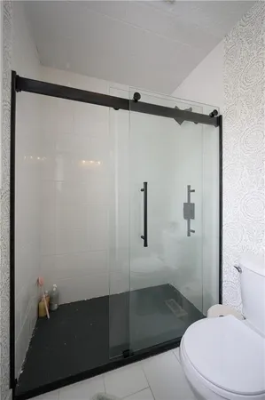 a bathroom with a shower and toilet