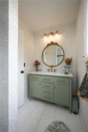 a bathroom with a granite countertop sink and a mirror