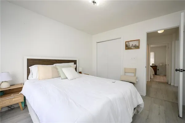 a bedroom with a bed and a lamp